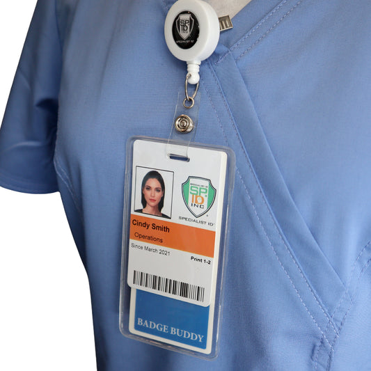 Cindy Smith, Operations, wears light blue scrubs with an ID badge in a vinyl pocket and a Vertical Badge Buddy Holder (P/N 1840-5013) attached to a retractable holder.
