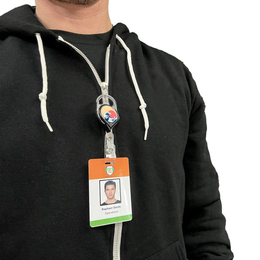 Person wearing a black hoodie, with a lanyard and ID badge displaying a photo, name, and department, attached to a Custom Printed No Twist Carabiner Badge Reel - Upload Your Logo. Sold by Specialist ID.