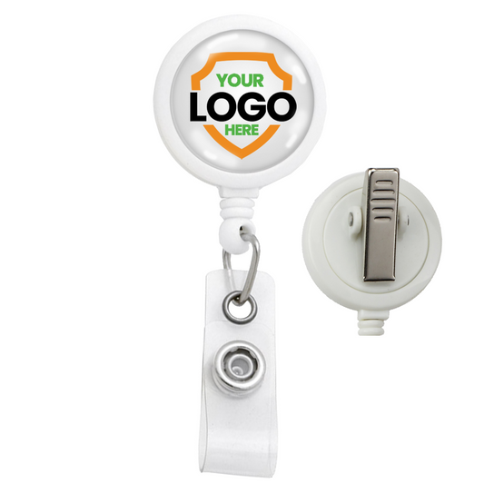 A white Custom Max Label Badge Reel with 1 Inch Smooth Face and Swivel Spring Clip - Personalize with Your Logo, perfect for promotional giveaways. The front features a round logo area with "YOUR LOGO HERE" text inside an orange shield design. Ideal for boosting brand awareness, the holder has a clear strap with a metal snap for attaching a badge.
