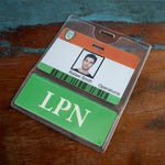 A photo of an ID badge holder displaying a person's photo, name “Rafael Smith,” and the word “Operations.” At the badge bottom is a separate green label with "LPN" written on it, labelled as Custom Printed BadgeBottoms® Horizontal (Badge Holder & Badge Buddy IN ONE).