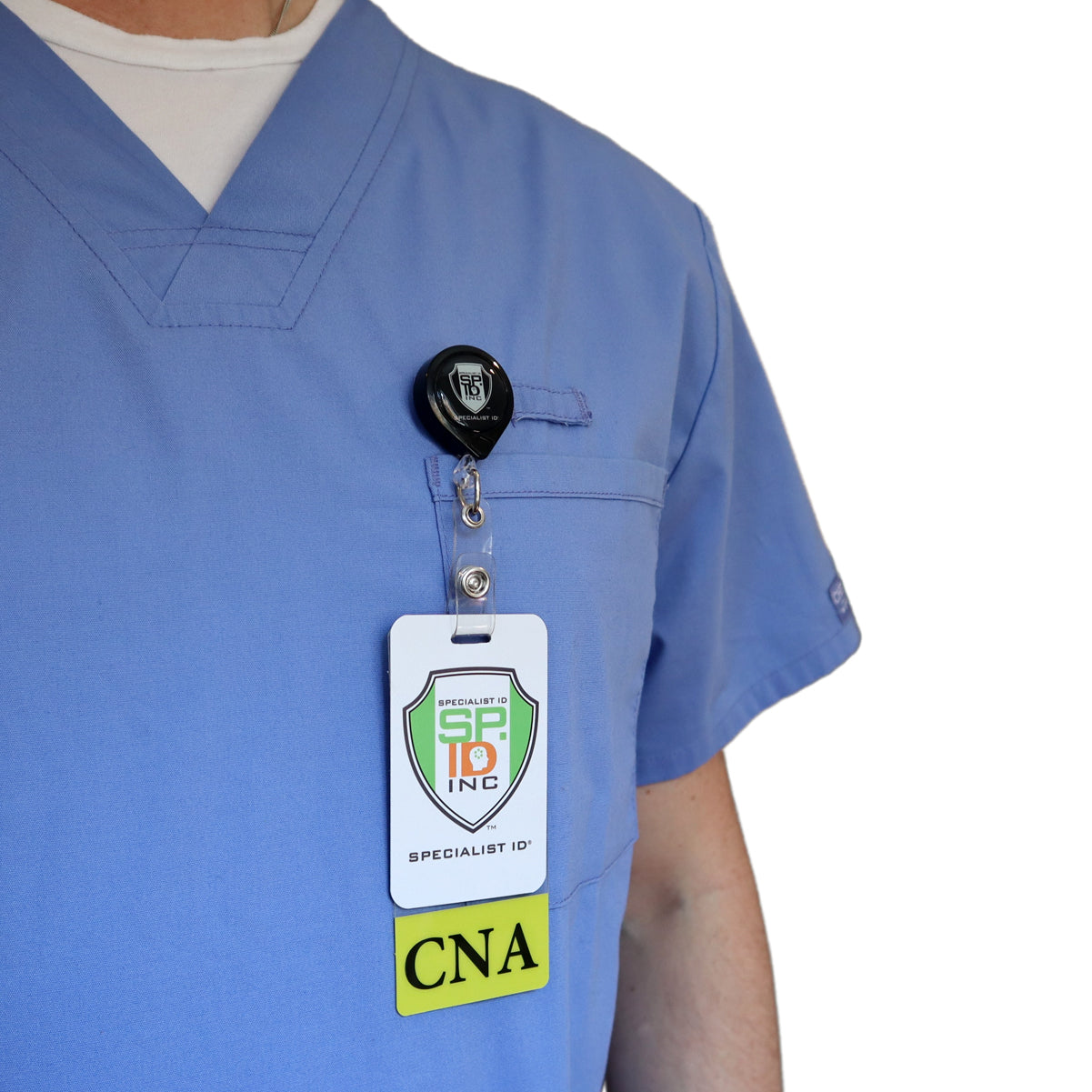A person wearing blue scrubs and a badge that reads "CNA" is shown from the shoulders to the waist. The Clear CNA Badge Buddy Vertical with Yellow Border for Nursing Assistants is clipped to the left chest pocket, providing nursing assistants with easy identification.