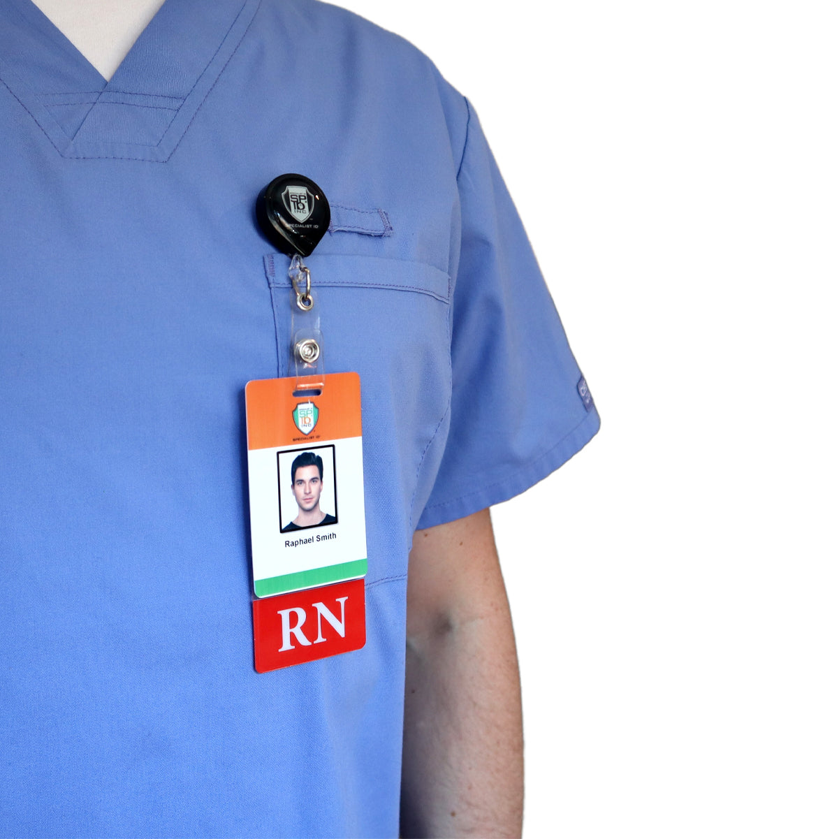Close-up of a person in light blue scrubs with a visible Clear RN Badge Buddy Vertical with Color Border for Registered Nurses - Double Sided Print clipped to the chest. The badge displays a photo, name, and "RN" designation in bold red text.