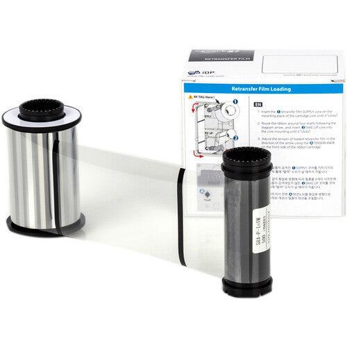 A clear IDP 653431 Retransfer Film for Smart-81 ID Card Printer - 500 Image Capacity (Ink Not Included), designed for the IDP Smart-81 card printing process, is depicted partially unwound, in front of its packaging box which contains instructional text and diagrams.