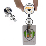 Person holding a Custom Heavy Duty Badge Reel with Key Ring and Badge Strap (SPID-3180) - Add Your Logo labeled "Carpet Service Cleaning and Repair," attached to keys and a Specialist ID badge with a clip on the back.