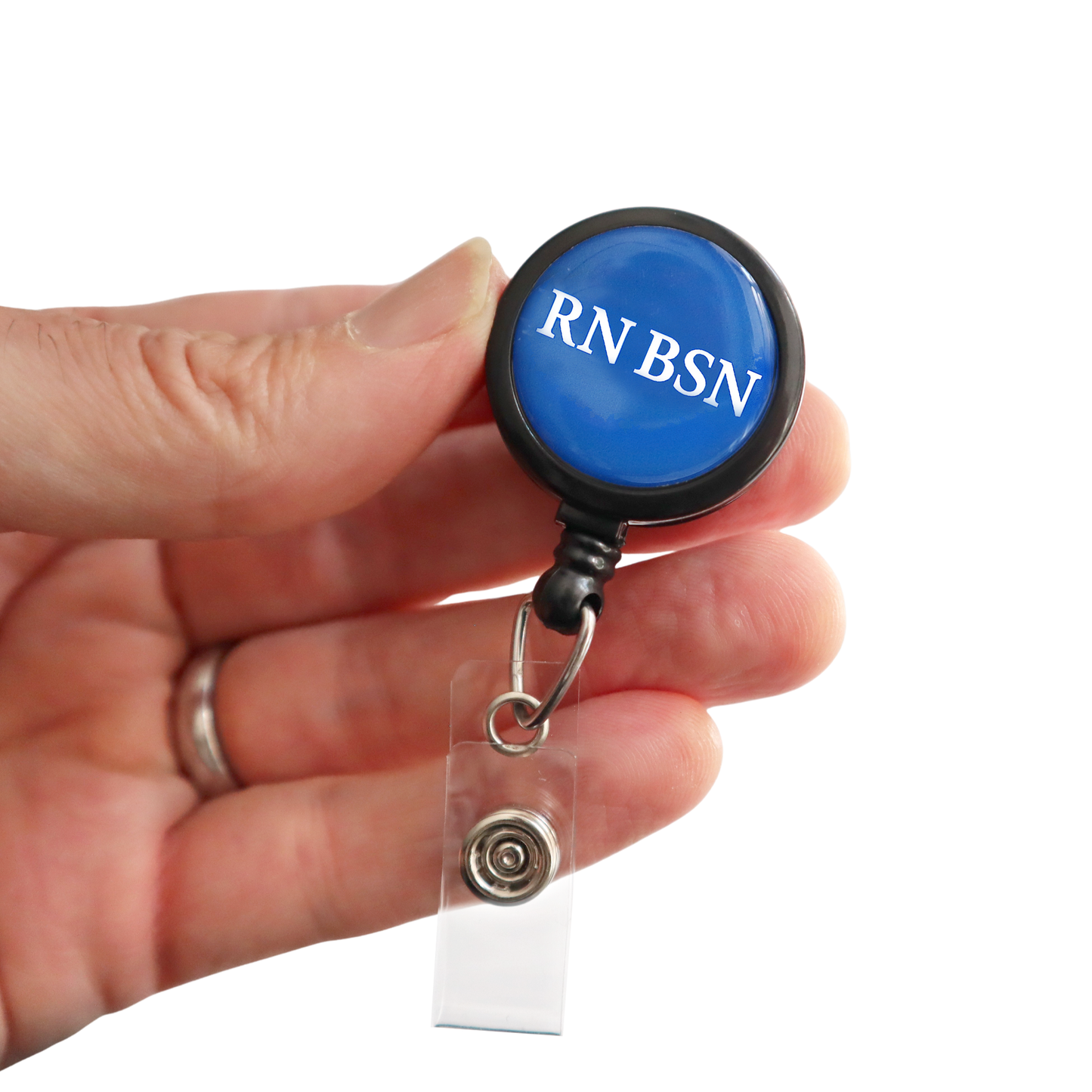 A hand holds the RN BSN Badge Buddy Reel with Swivel Spring Clip, a blue retractable reel and badge buddy in one for nurses, labeled "RN BSN" in white letters.