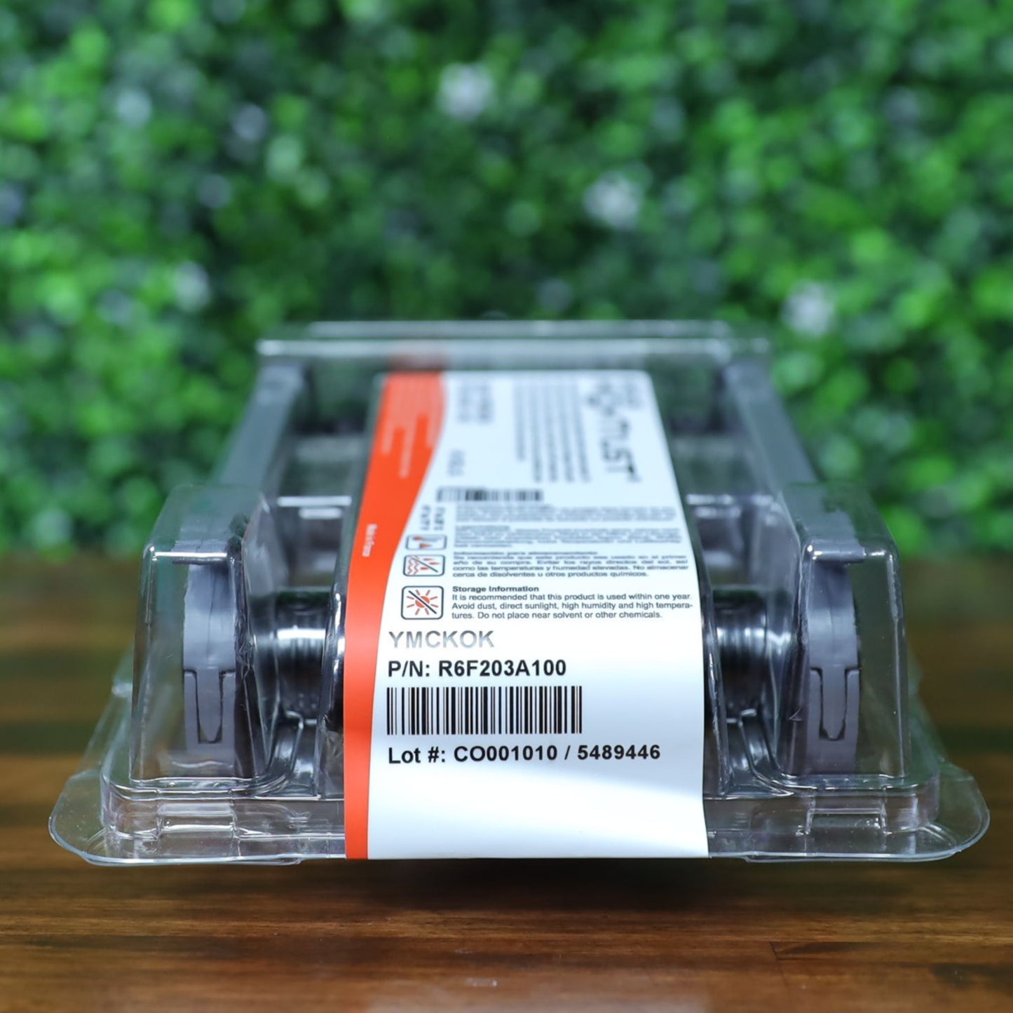 Angled front-right view of the Evolis R6F203A100 YMCKO-K ribbon in sealed packaging, showing the white product label with part number, lot number, and YMCKOK panel designation. Photographed and sold by Specialist ID, an authorized Evolis dealer.