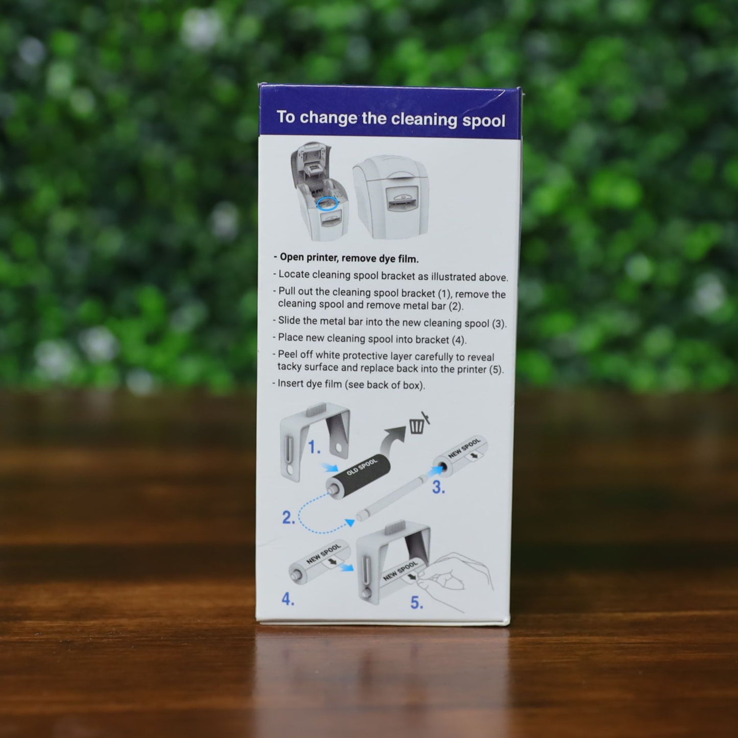 Side panel of the Magicard MA1000K-White ribbon box showing detailed cleaning spool replacement instructions. Includes step-by-step visuals for removing and replacing the cleaning spool with labeled diagrams. Photographed and sold by Specialist ID, an authorized Magicard dealer.
