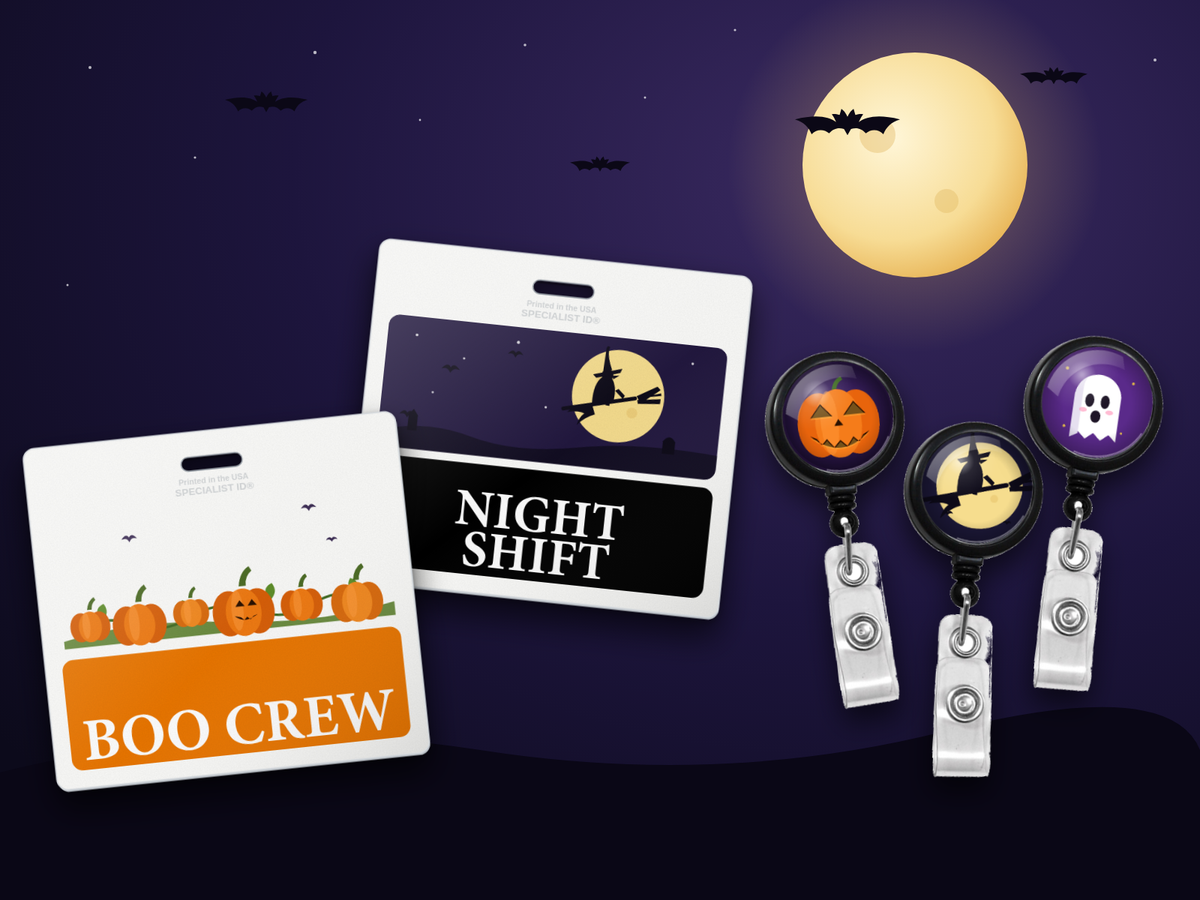 Orange BOO CREW custom badge buddy with a printed pumpkin patch, a black NIGHT SHIFT badge buddy with a flying witch, and badge reels with jack-o'-lantern, witch and ghost dome labels