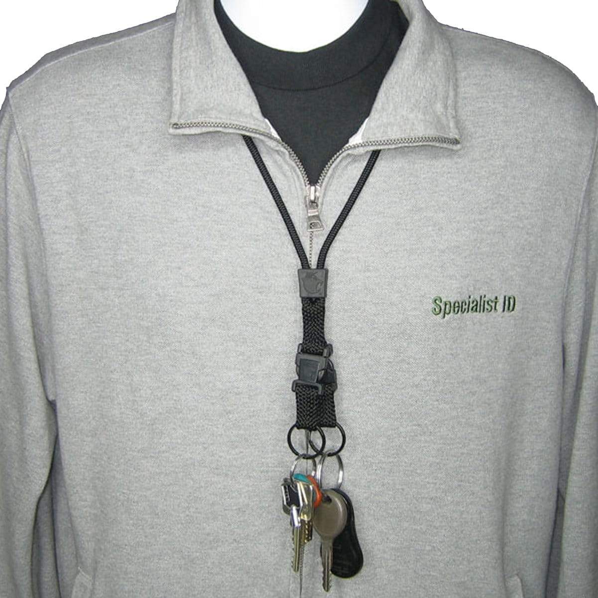 Person wearing a gray zip-up jacket with an EK Black Lanyard With Two Detachable Key Rings (10046) by EK USA holding multiple keys clipped to it. The jacket has "Specialist ID" embroidered on the left side.