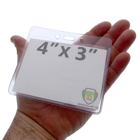 A hand holding a **HEAVY DUTY Textured 4x3 Horizontal Name Badge Holder - Plastic Pass Protector for Conference, Trade Show Events (1815-1400)** with the dimensions "4'' x 3''" printed on the insert inside.
