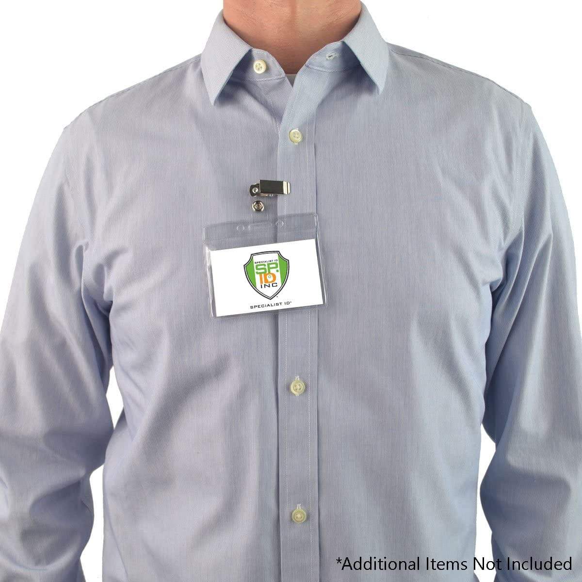 A person wearing a light blue button-down shirt with a Standard Horizontal Vinyl ID Badge Holder (1820-1000) attached to the top pocket, displaying a logo. Text at the bottom reads "Additional Items Not Included.