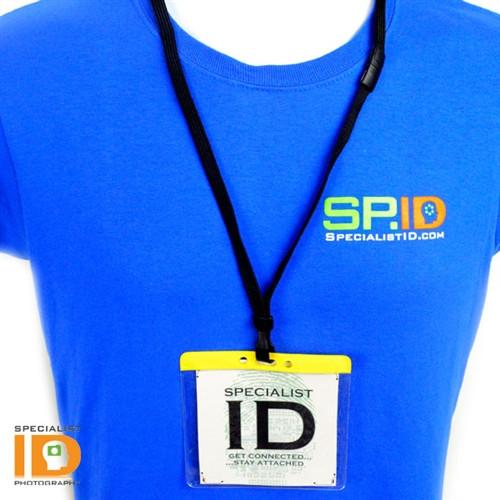 A person wearing a blue shirt with the "SPECIALISTID.COM" logo and a lanyard holding an Extra Large Color Code Badge Holder for 4x3 Badges - Horizontal Vinyl with Color Bar (1820-120X) that reads "SPECIALIST ID Get Connected...Stay Attached.