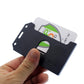 A hand holding a 2 Sided Rigid Vertical MultiCard Badge Holder - Hard Plastic Multiple ID Card Holder (1840-308X) with a partially visible card displaying a green shield icon.