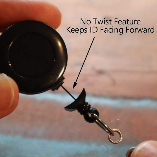 Close-up of a hand holding a "No Twist" Badge Reel With Clear Vinyl Strap And Belt Clip (P/N 2120-305X), featuring a no-twist component to keep the ID facing forward. An arrow points to the no-twist feature for added convenience.