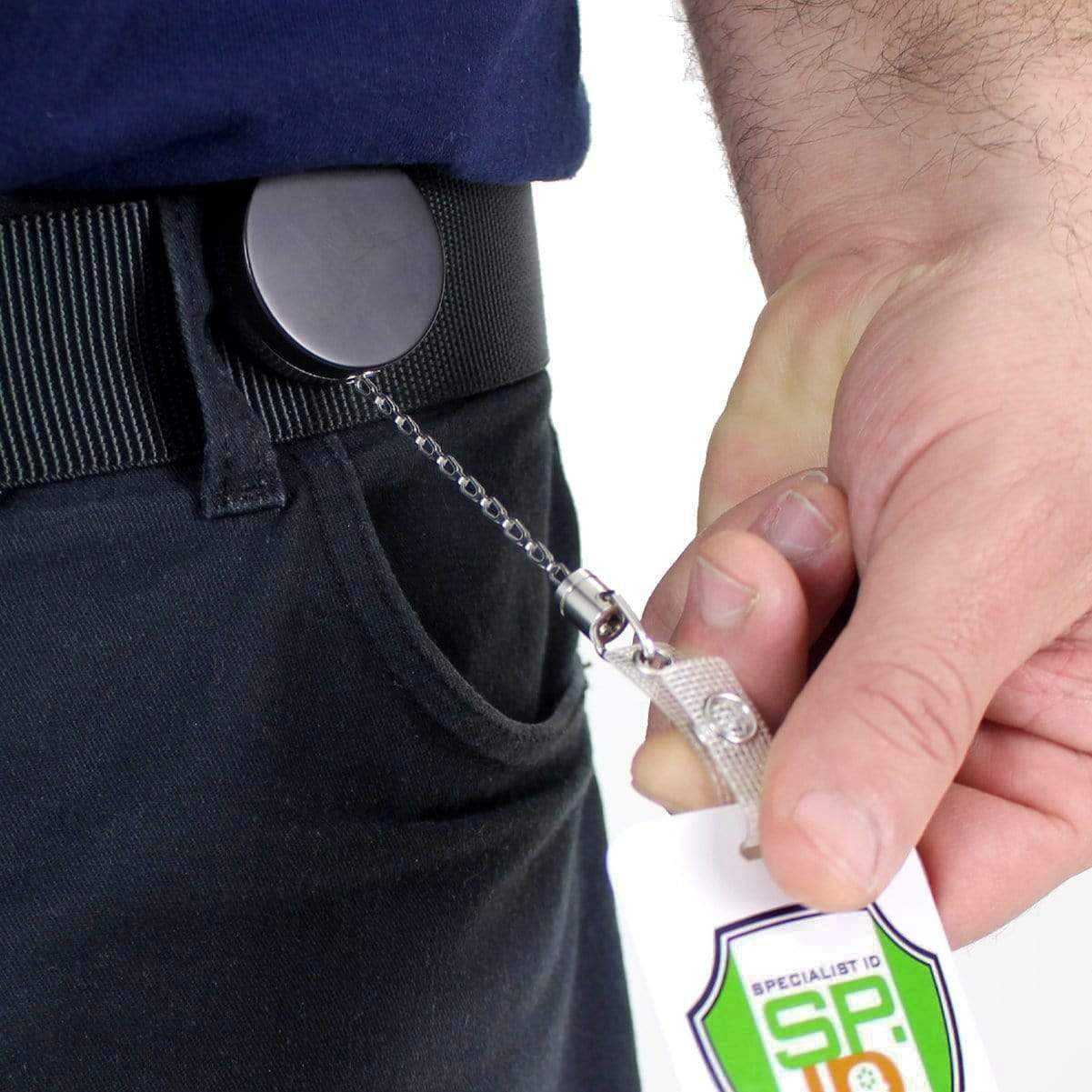 A person wearing a black belt clips a Heavy Duty Badge Reel With Chain (P/N 2120-3375) to their belt loop, holding an ID card with a Specialist ID logo.
