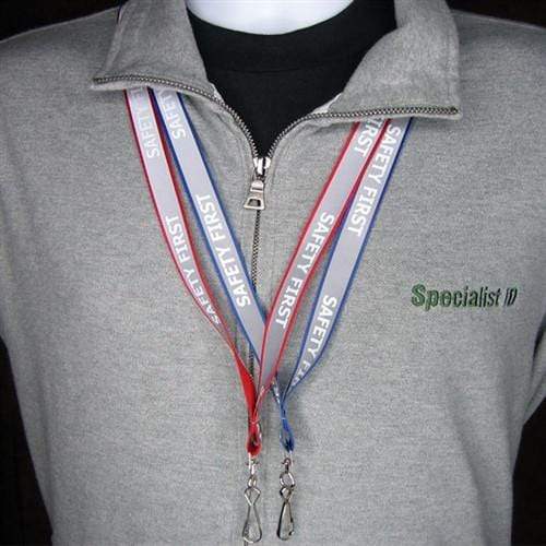 Person wearing a gray sweatshirt with "Specialist ID" embroidered on it, two Reflective "Safety First" Printed ID Neck Lanyard With Metal Swivel Hook 2135-25XX hanging around their neck.