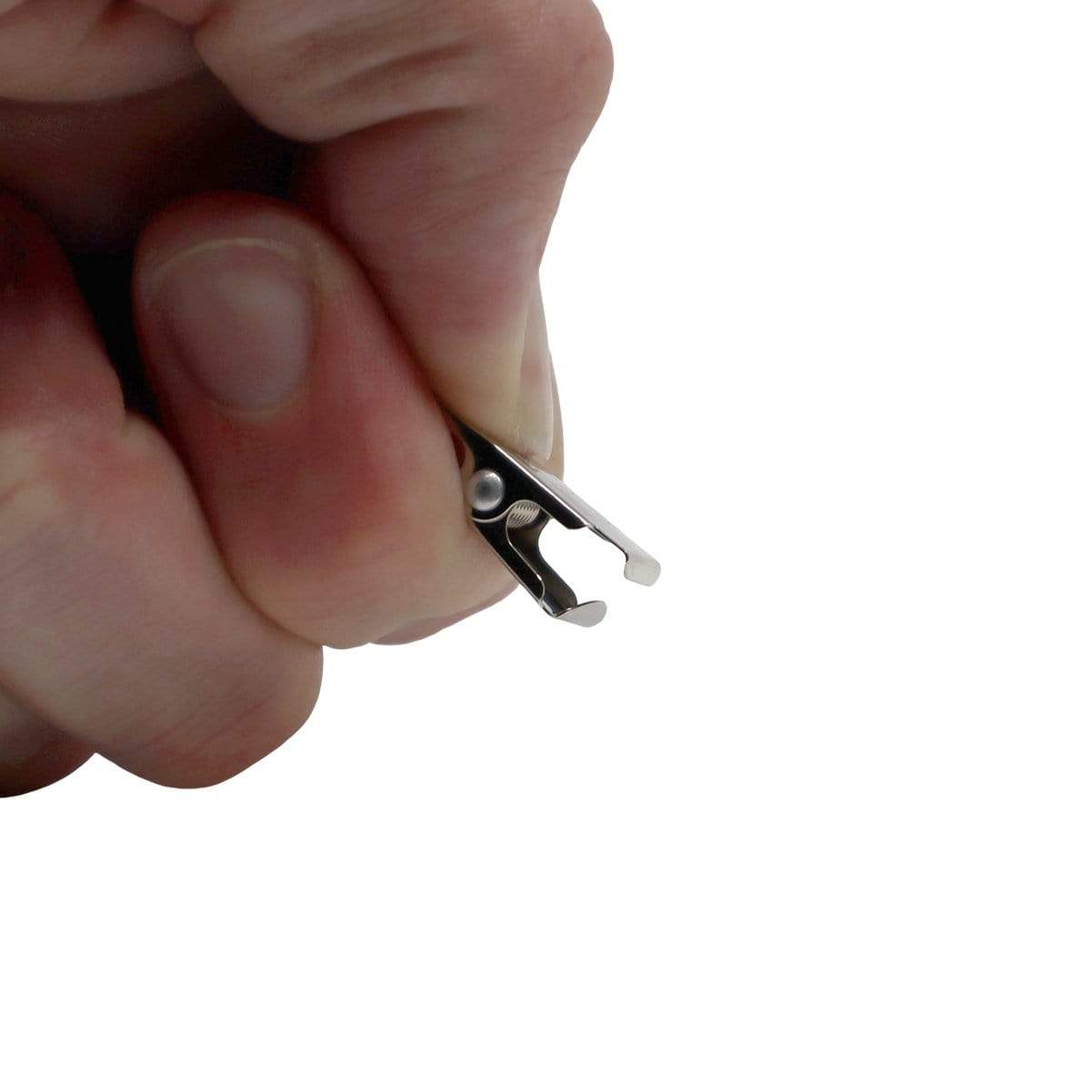A hand holding a small metal object, possibly a Premium Breakaway Lanyard with Bulldog Clip (2137-600X).
