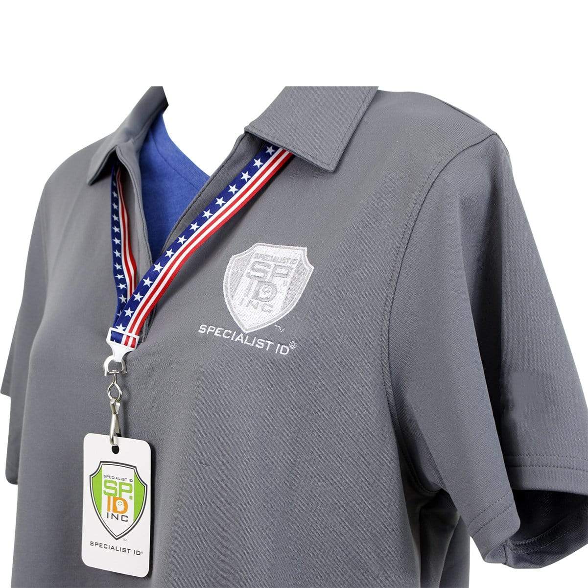 A close-up of a person wearing a gray polo shirt with a Specialist ID logo, paired with an American Flag Breakaway Lanyard with Swivel Hook (P/N 2138-5081) adorned in patriotic stars and stripes, and an attached badge.