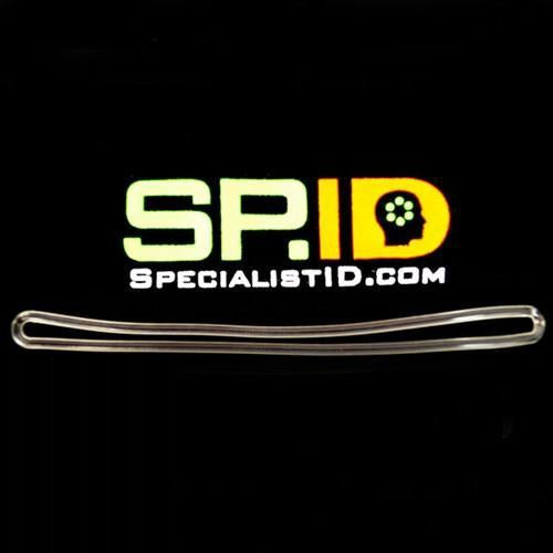 A 6" Plastic Luggage Tag Loop Straps in Solid Colors - Red, Green, Black, Blue & White (2410-200X) is displayed above a clear plastic badge holder loop set against a black background, featuring flexible rugged loops with a 6" length for added durability.