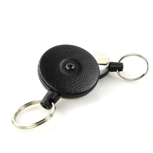 A black Key-Bak #485B-HDK Self Retracting Key Reel with a tough Kevlar cord and a metal keyring on each end, perfect for security enforcement professionals.