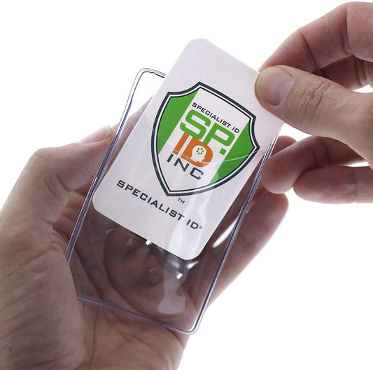A person is inserting a Specialist ID, Inc. identification card with a green and orange logo into a Premium Vinyl Vertical Badge Holder (506-N).