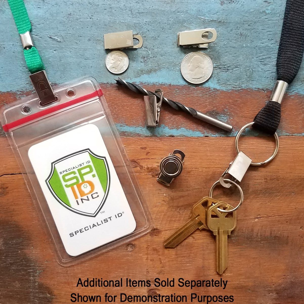 A Bulldog Clips for DIY Lanyards and Arts and Crafts - Alligator Style Metal ID Clip (5705-3542) with a green lanyard and black lanyard combo, equipped with keys, drill bits, and a nickel-plated steel bulldog clip are arranged on a wooden surface. Additional items sold separately. Shown for demonstration purposes.
