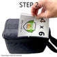 Hand holding an Extra Long 9" Luggage Tag Loop - Clear Worm Loops for Luggage Tags (2410-2100) with a durable flexible strap above a black bag with "STEP 2" text above the luggage tag loop. Note: Bag & Luggage Tag Loops Sold Separately.