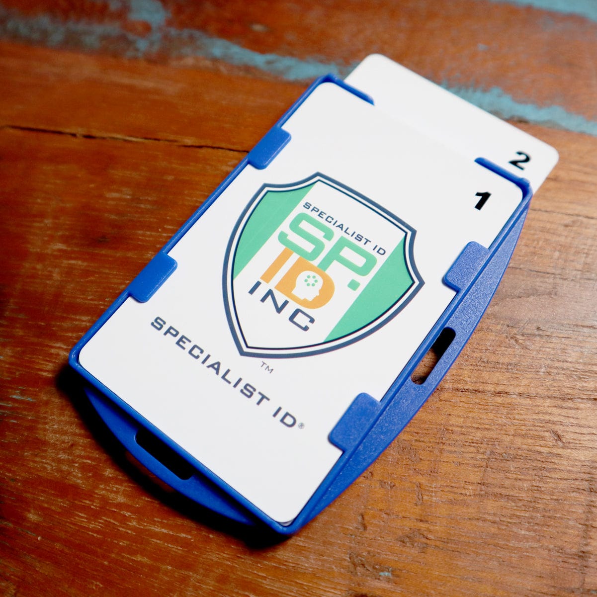 A SkimSAFE FIPS 201 RFID Blocking 2-Card ID Holder (AH-210) securely holding cards with the 'Specialist ID Inc' logo, featuring RFID blocking for enhanced security.