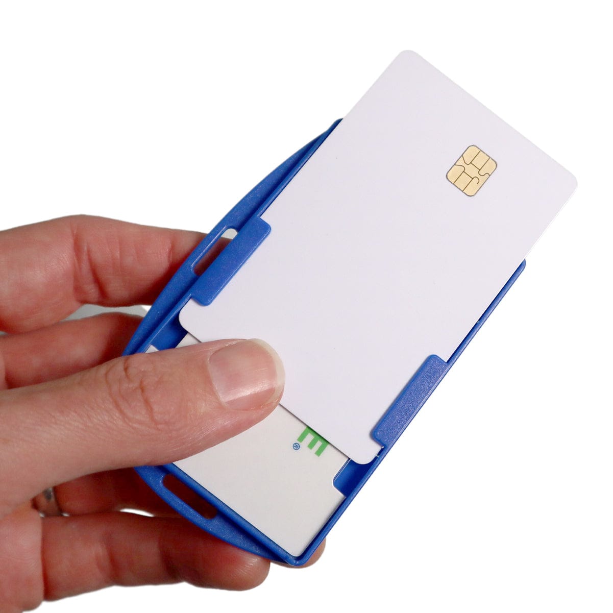 A hand holds a white smart card with a visible gold chip, which is partially inserted into a blue SkimSAFE FIPS 201 RFID Blocking 2-Card ID Holder (AH-210), acting as an ID holder with FIPS 201 compliance.