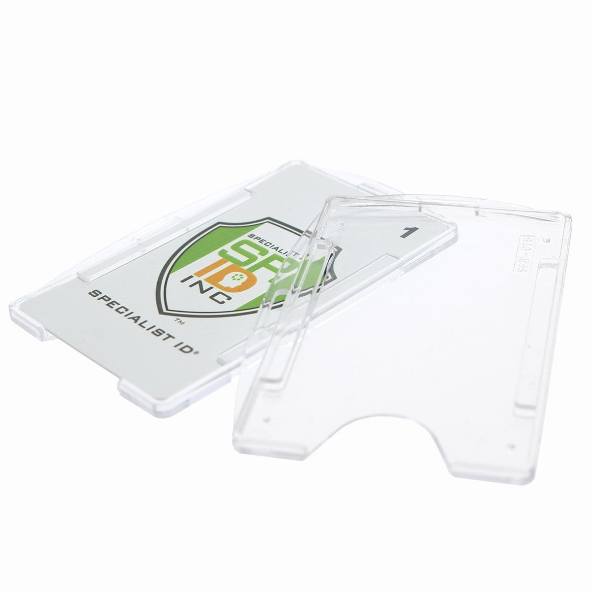 A Crystal Clear Rigid Open-Faced Single ID Card Holder (P/N SPID-075) with a partially visible card featuring a green and orange logo and the text “Specialist ID”. The holder, made from durable polycarbonate material, is open, showing its front and back parts along with adaptable slot holes for versatile attachment options.