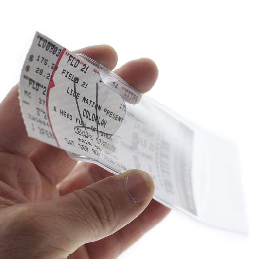 A person holding a Clear Ticket Holder for 2 1/8 X 5 5/8 Inch (Ticketmaster Size) Concert and Sporting Event Tickets & Credentials (SPID-1140) with a collectible concert ticket inside for a Coldplay event. The ticket shows details like seat number and price.
