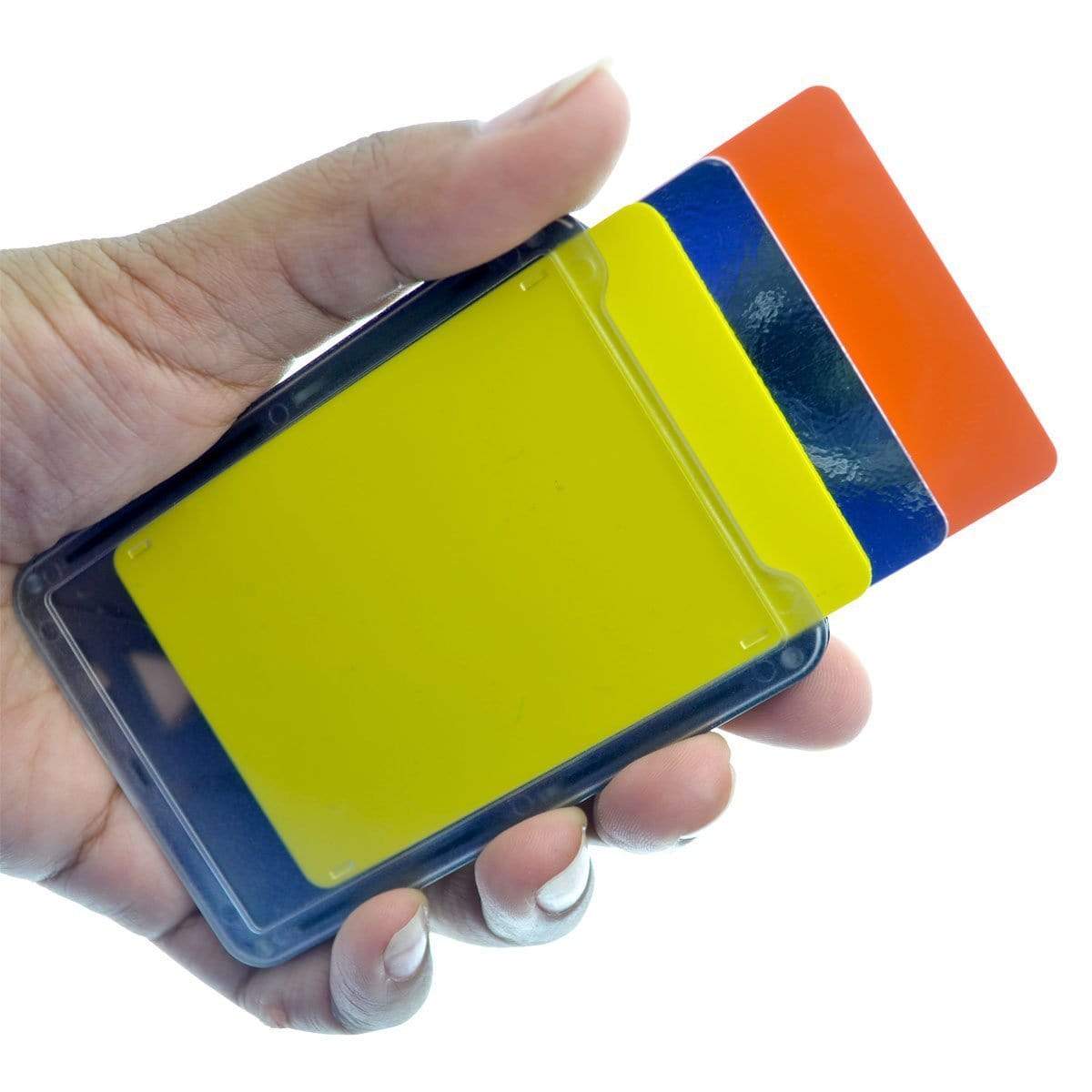 A hand holding a Top Loading THREE ID Card Badge Holder with Heavy Duty Lanyard w/ Detachable Metal Clip and Key Ring by Specialist ID, including yellow, blue, and red cards, partially slided apart.