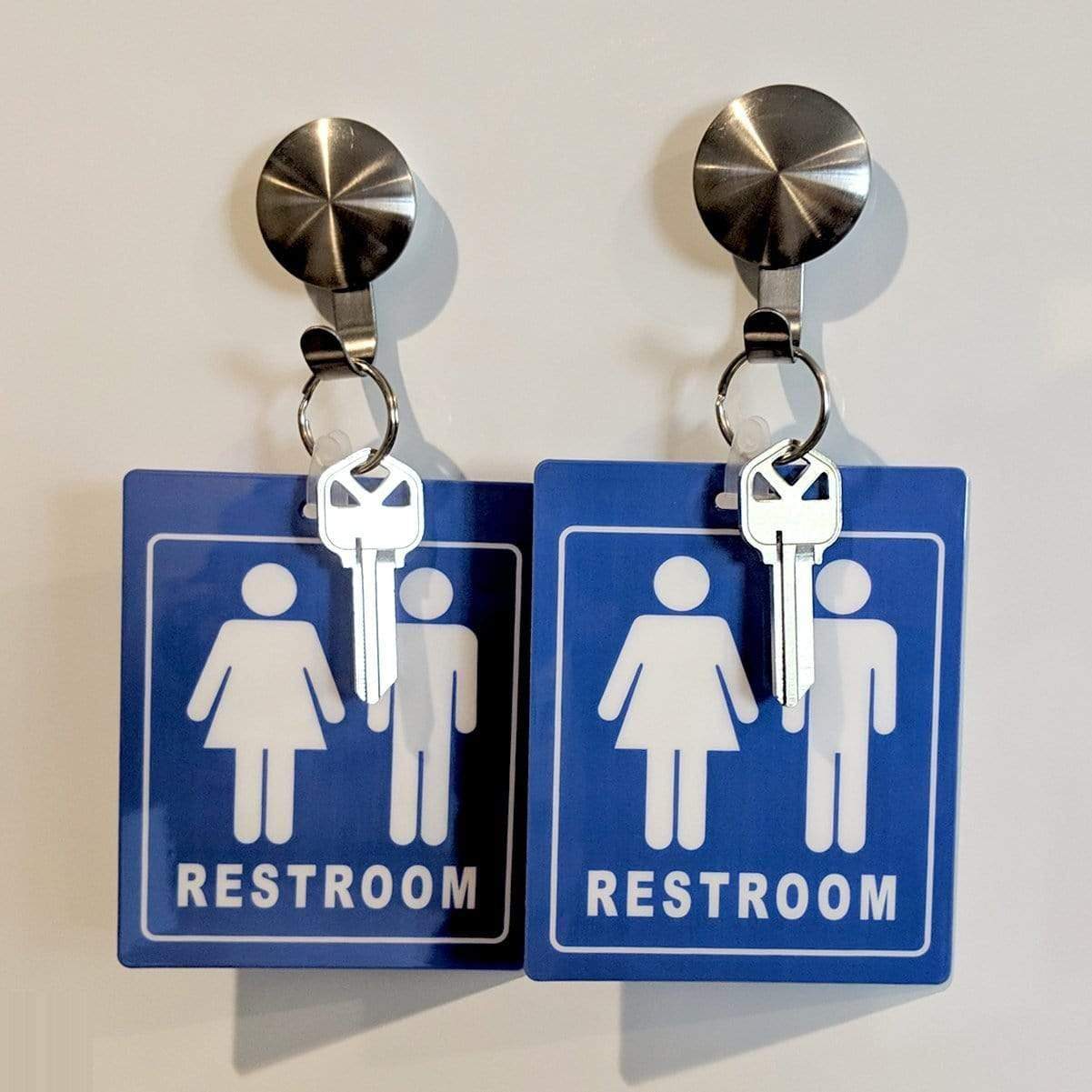Two Unisex Restroom Pass Keychains - Bathroom Tag with Key Chain Ring - Heavy Duty Large Passes for Unisex & Family Restrooms with Key Holder (Sold in 2 Pack) (SPID-9840-Blue), each hanging from metal hooks.