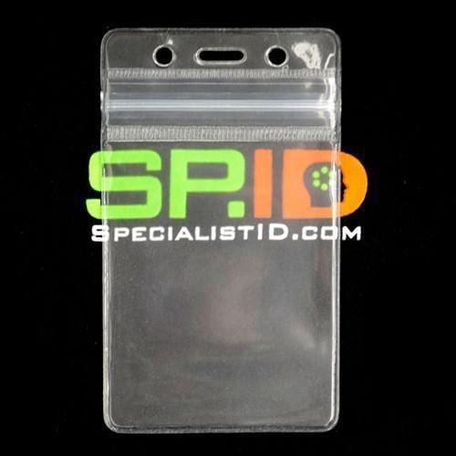 A Clear Vertical Vinyl Badge Holder with Zipper (506-ZS-CLR) with the text "SP.ID SPECIALISTID.COM" printed on it, featuring a sealed top and two punch holes for attachment, ensuring secure ID badge security.