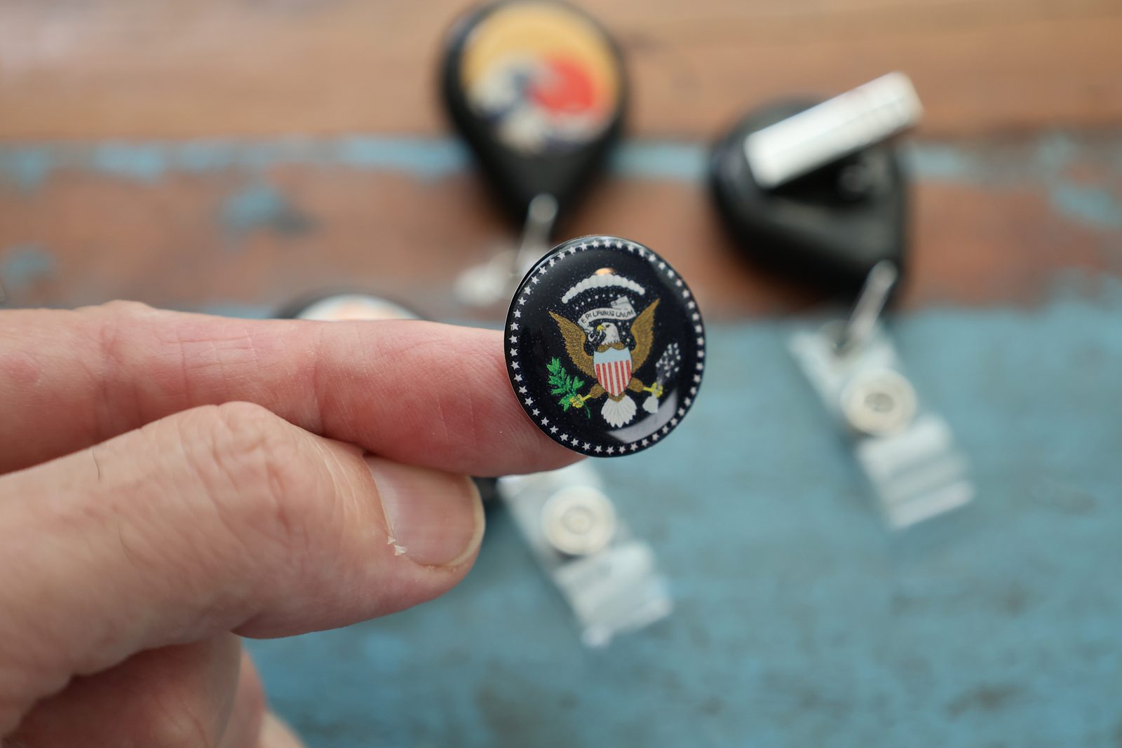 Department seal under a dome on a mini reel