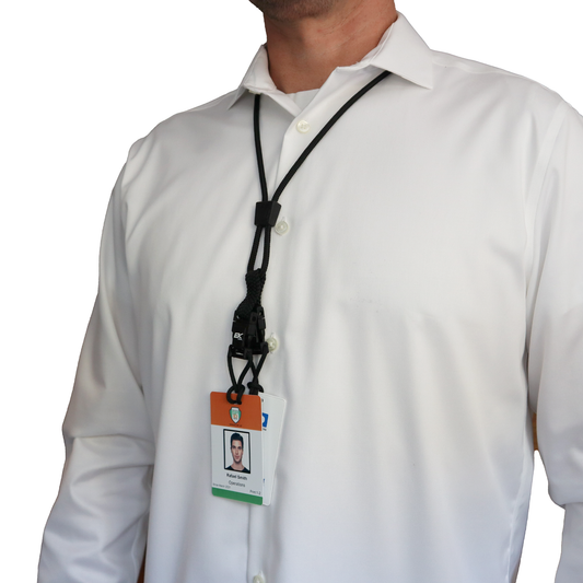 A person wearing a white shirt sported an ID badge on a Black EK Lanyard Plus II with Two Detachable Soft End Loops around their neck. Sold by Specialist ID.
