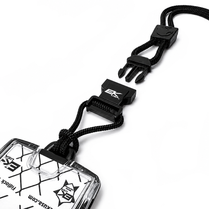 The EK USA One Hander RFID Blocking Badge Holder (10983) features a geometric design, visible text, and comes with a black detachable lanyard and plastic clasp, all shown on a white background.