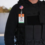 Customized badge reel with American Flag design shown on police man wearing tactical gear