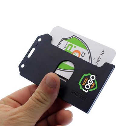A hand holding a black plastic cardholder with a card partially visible inside. The Custom 2-Sided Rigid Vertical Multi-Card Holder (1840-308X) - Add Your Logo features a slot for the card and a logo placeholder on its front, offering brand recognition and enhancing your professional look.