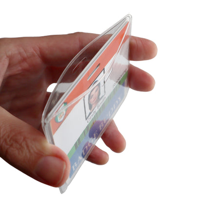 A hand holding a Horizontal Badge Buddy Holder (P/N 1840-5014) containing an identification card.