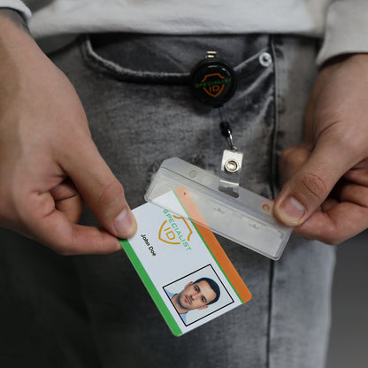 A person holds a Swipe Card Holder - Rigid Horizontal Half Card Badge Holder - Leaves Mag Stripe Exposed for Easy Swiping (1840-8000) with an ID card and retractable badge reel.