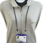 A person wearing a grey zip-up sweater with a lanyard around their neck, holding an ID badge in a Custom Horizontal Open-Face Rigid Plastic Card Holder (1840-811X) - Add Your Logo.