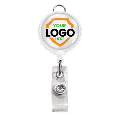 White badge reel with a metal clip and a circular area for a customizable logo within an orange shield shape, accompanied by a clear plastic strap. Ideal for brand awareness, the Custom Badge Reel with Belt Clip and Lanyard Attachment - Add Your Logo can feature your personalized graphic to make your brand stand out.