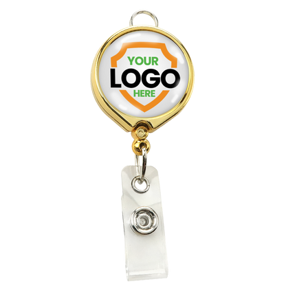 A Custom Badge Reel with Belt Clip and Lanyard Attachment - Add Your Logo, perfect for enhancing brand awareness, with a gold-colored clip and a customizable area showcasing a shield outline with the text "YOUR LOGO HERE" in the center.