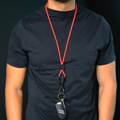 Person wearing a black t-shirt and a Heavy Duty Breakaway Round Lanyard With Detachable Key Ring (2135-454X) around their neck, holding keys and a key fob.