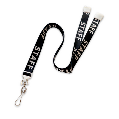 The STAFF Lanyard with Standard Swivel Hook 2138-5210 is black with "STAFF" printed prominently in white, designed with a metal clip and swivel hook. It also features a breakaway mechanism at the neck for enhanced safety.