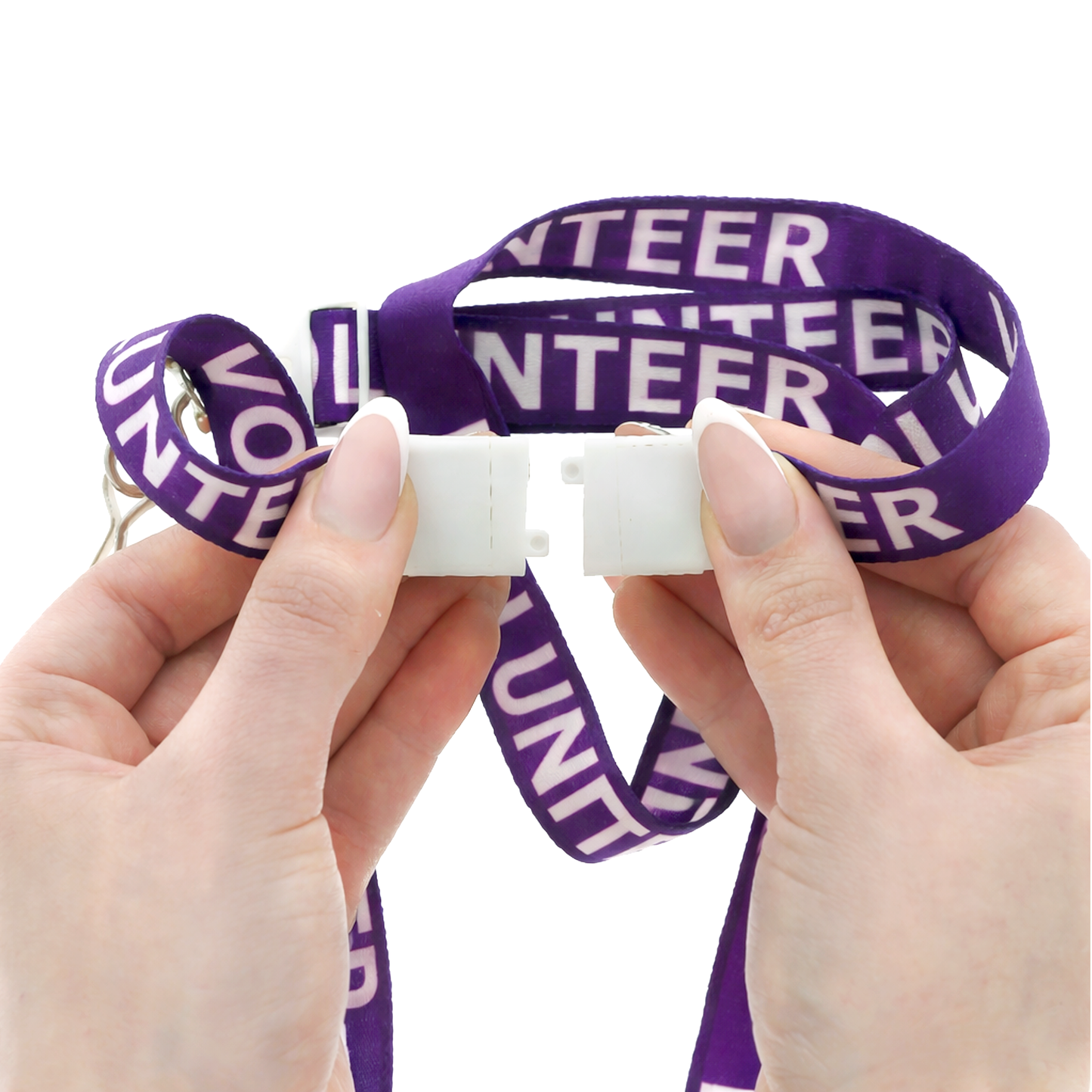 Purple 'VOLUNTEER' lanyard held by hands against a white background. Featured breakaway clasp shown detached. Sold by Specialist ID.