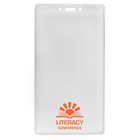 A Customizable 4 X 7 Clear Vertical Large Event Badge Holder (306-4258) with a rectangular shape. It features the text "LITERACY CONFERENCE" in orange, accompanied by a sunrise graphic and an open book illustration. This customizable badge holder is perfect for large events, adding a personalized touch to every attendee's experience.