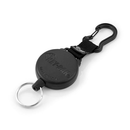 A black Key-Bak SecureIt Super Duty Gear Reel #488B-SDK with a carabiner clip, designed for attaching keys or small tools. The casing is round and labeled "KEY-BAK SecureIt.