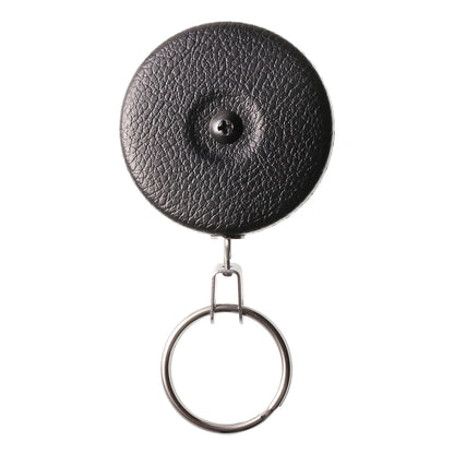 A durable Key-Bak #5B Self Retracting Heavy Duty Key/Badge Reel with a key ring attached to a round, black, textured leather design featuring a central rivet and self-retracting mechanism.